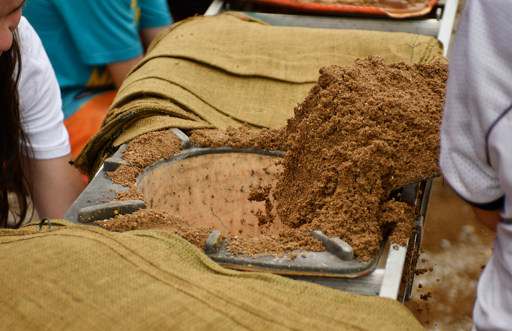 Mokane local Isaak Rand dumps dirt into the top of a cone